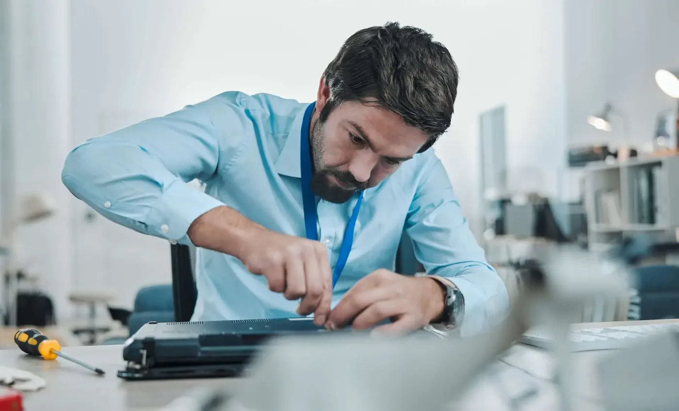 IT technician opening up hardware at a workbench